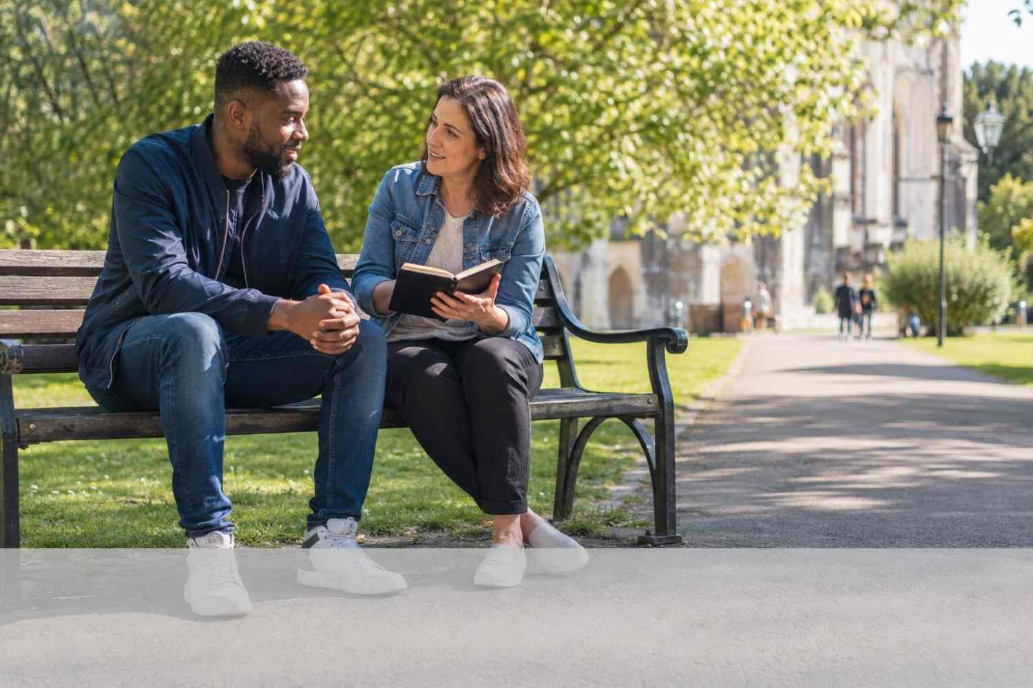 Two people chatting in park